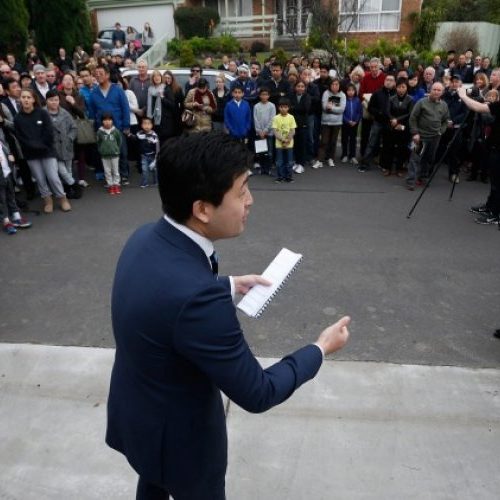 Auctioneer surrounded by crowd