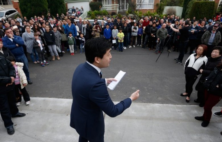 Auctioneer surrounded by crowd