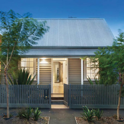 Small tin roof house with picket frence