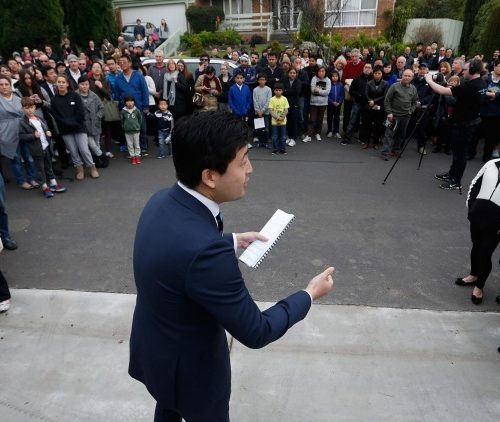 Auction snapshot - Auctioneer surrounded by crowd