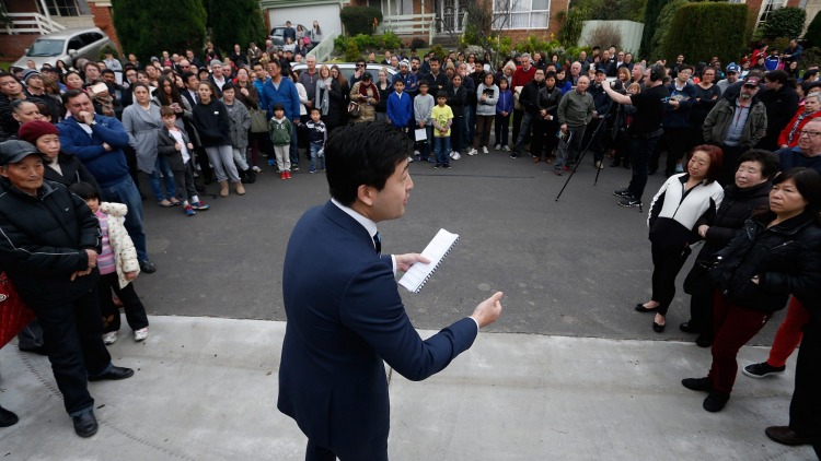 Auction snapshot - Auctioneer surrounded by crowd