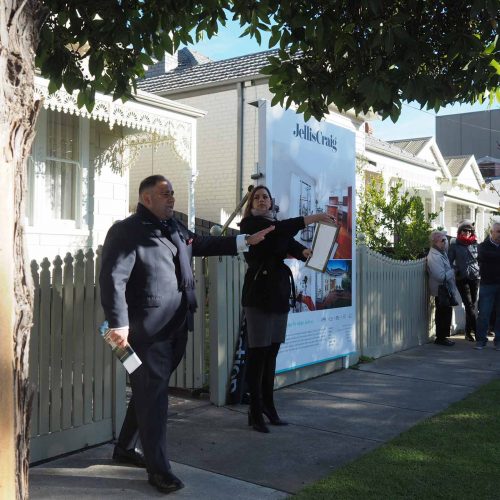 Auction snapshot - auction underway in front of picket fence