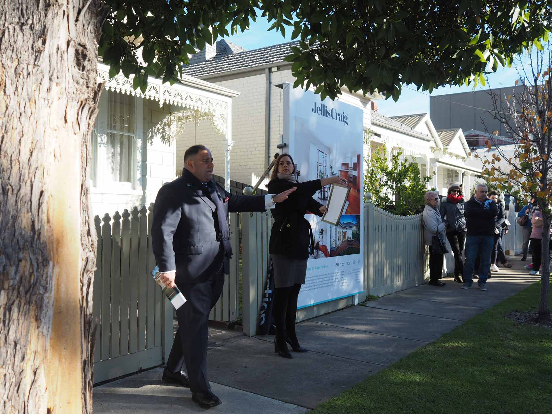 Auction snapshot - auction underway in front of picket fence