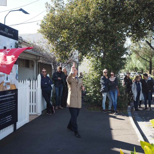 Auction snapshot - Auctioneer in brown coat calling auction