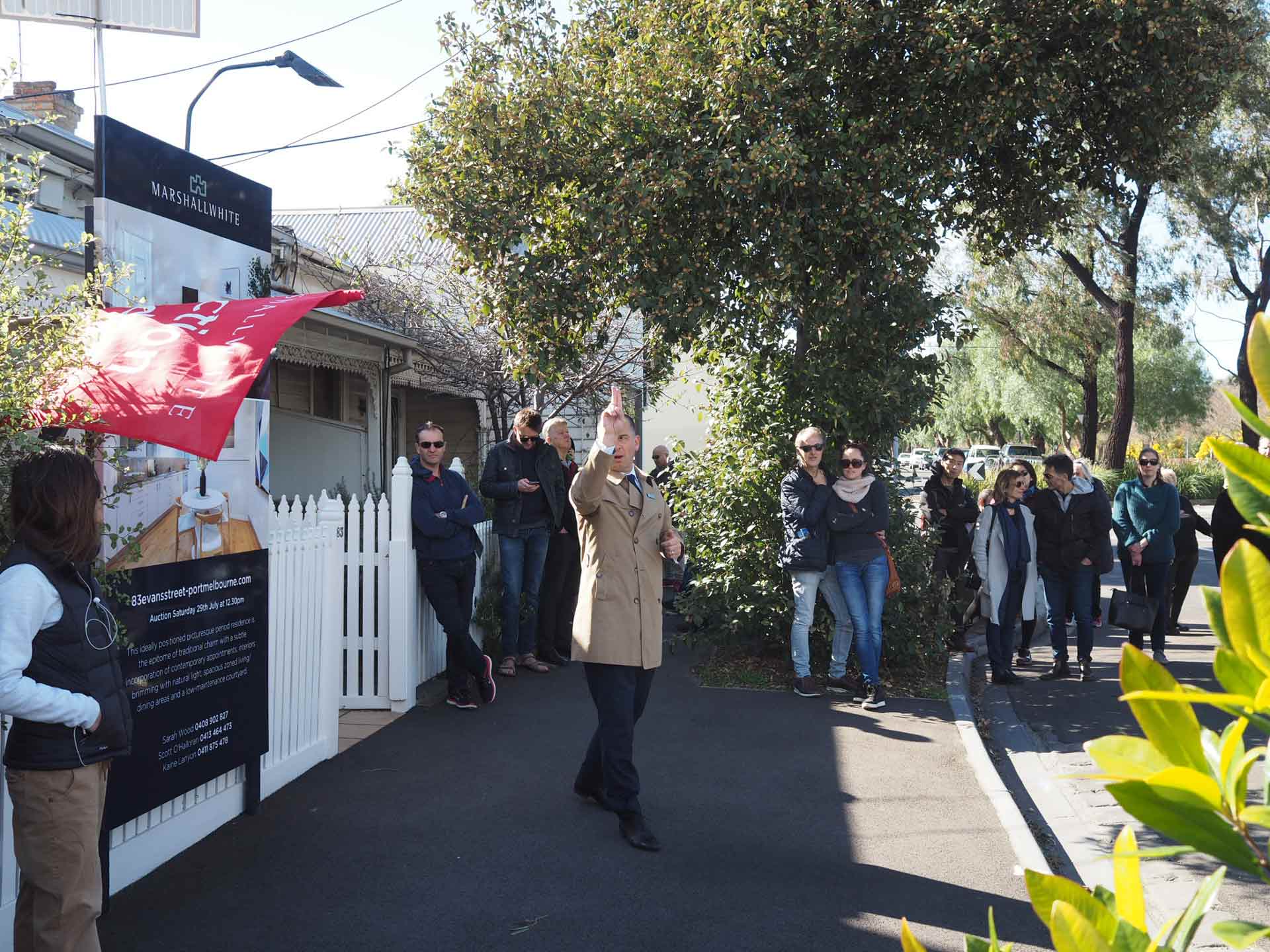 Auction snapshot - Auctioneer in brown coat calling auction