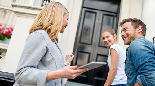 Real estate agent showing young couple a property