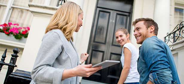 Real estate agent showing young couple a property