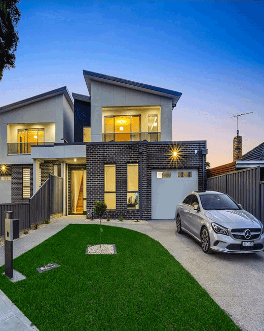 Modern home with car in driveway