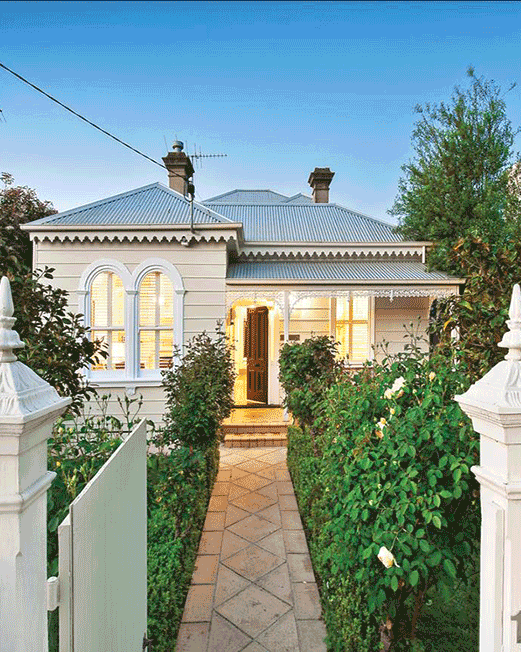 Front path leading to cosy home past garden