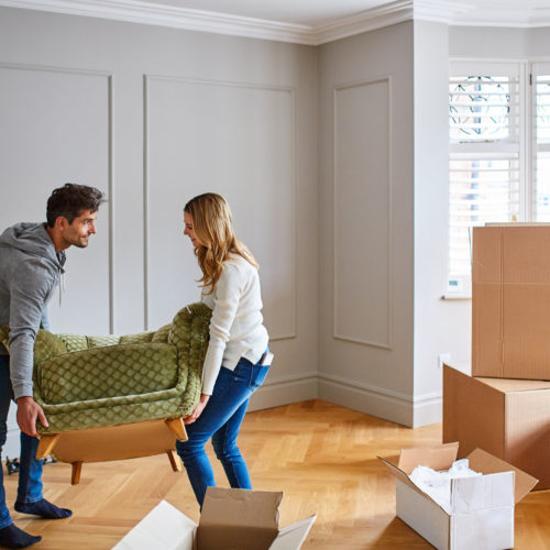 Young couple moving chair