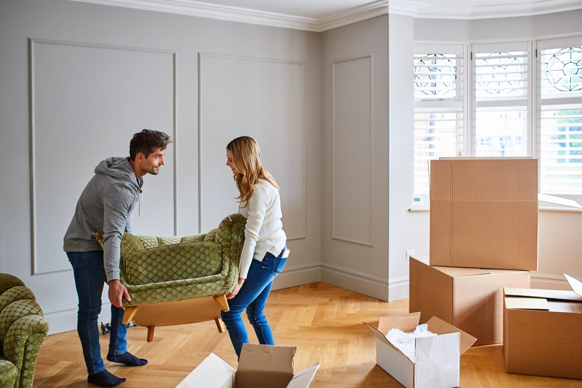 Young couple moving chair