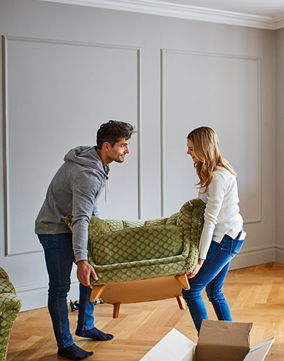 Young couple moving chair