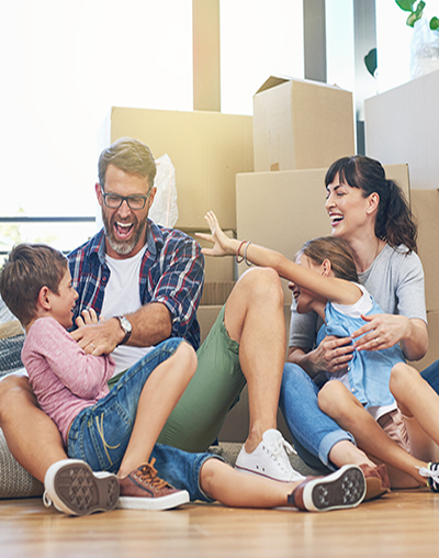 Happy family in front of moving boxes